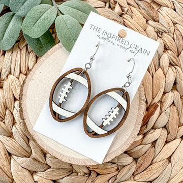 Wooden earrings with football design on a woven mat with 'The Inspired Grain' card.