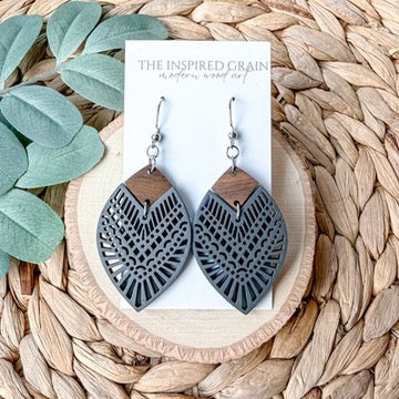 Wooden teardrop earrings with charcoal mandala pattern.