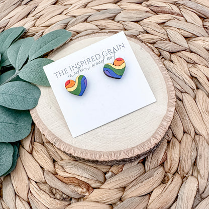 Rainbow heart earrings on a branded card with a natural background